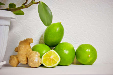 lime and ginger on a white background, making warming tea and refreshing lemonadeの写真素材
