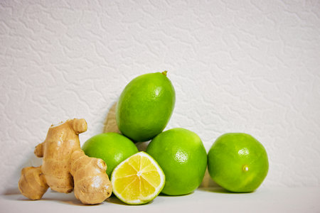 lime and ginger on a white background, making warming tea and refreshing lemonadeの写真素材