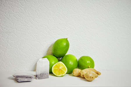 lime, ginger and tea bags on a white backgroundの写真素材