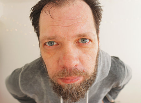 bearded sweaty man after hard work look at the cameraの写真素材