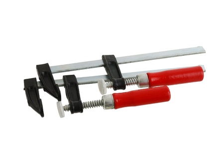 Pair of metallic clamps with red handle isolated on white backgroundの写真素材