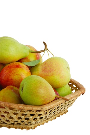 Cropped closeup of fresh pears, peaches and nectarines in interwoven basket isolated on white backgroundの写真素材