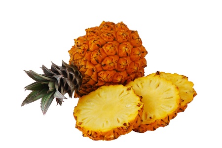 Two fresh bright orange pineapples one whole and one sliced isolated on white background