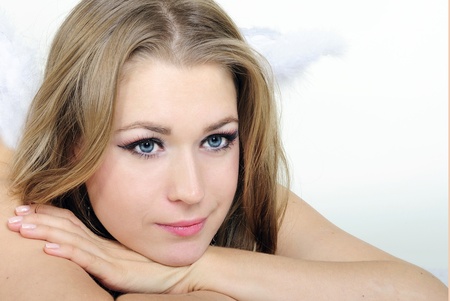 The young beautiful girl an angel with a gift on a white background の写真素材