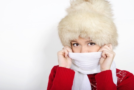 The young beautiful girl in a fur cap and a red sweaterの写真素材