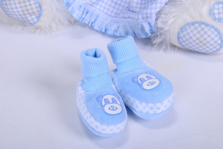 Blue small children's bootees on a white backgroundの写真素材