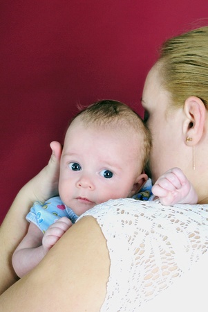 The little boy with the big eyes at mum on handsの写真素材