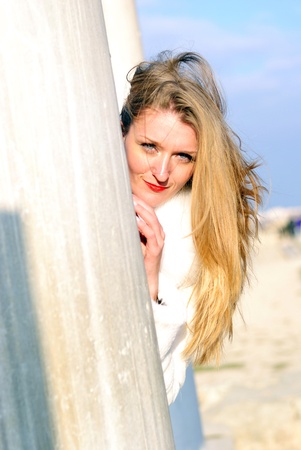 The young beautiful girl in a white fur coat with red lipstickの写真素材