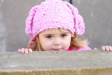 Portrait of the small beautiful girl with in a pink cap の写真素材
