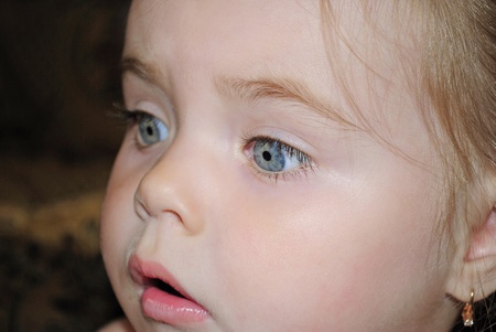 Portrait of the small beautiful girl with an astonished faceの写真素材