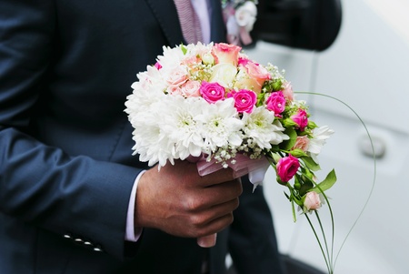 Wedding beautiful bouquet in a hand of the groomの写真素材