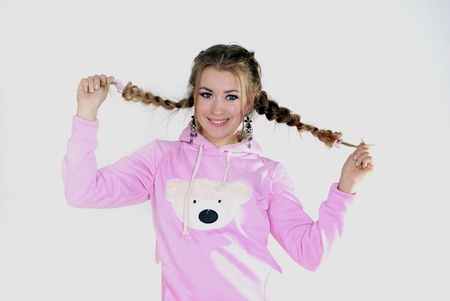 The young beautiful girl in a pink jacket with wings on a white background の写真素材