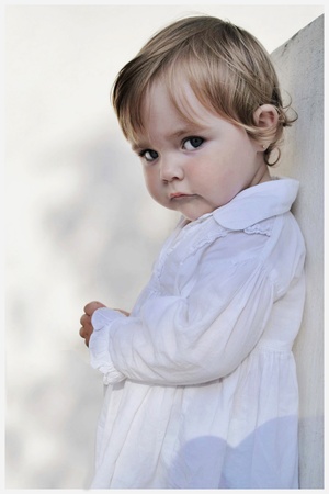 small beautiful girl in white gownの写真素材