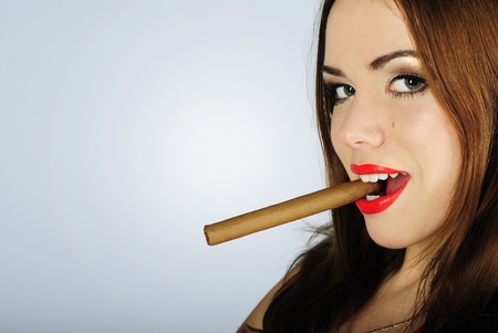 making look younger beautiful girl with red pomade with cigarの写真素材