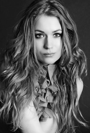 young beautiful girl in blue blouse with long hair on gray background
の写真素材