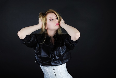 Beautiful girl blonde in white and black shirt on black background
の写真素材
