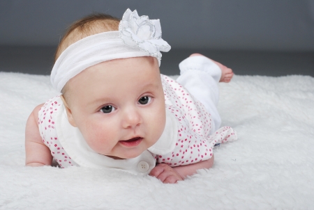 small girl on white background in gown and with flower on head
の写真素材