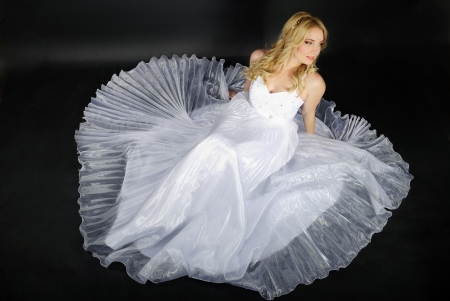 beautiful blonde in white gown on gray background