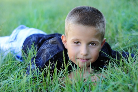 The boy on the grass in the Parkの写真素材