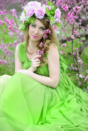 Beautiful girl in a flowered garden peach
の写真素材