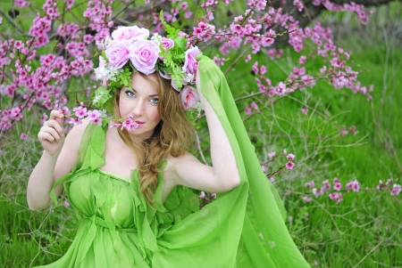 beautiful girl in the flowered garden peachの写真素材