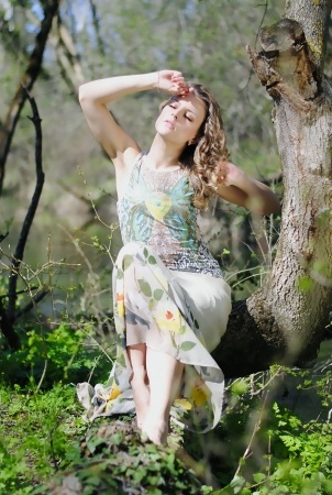 beautiful girl in green wood by summerの写真素材