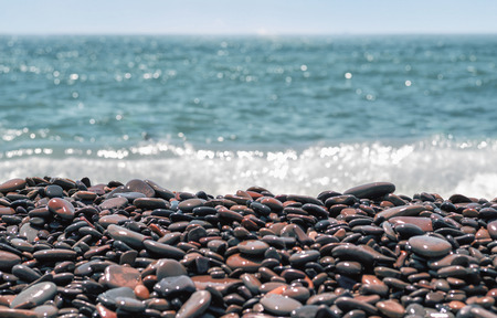 Pebble beach of Novorossiysk. The Village Of Shirokaya Balka.Close-up on the background of the blurred sea.の写真素材