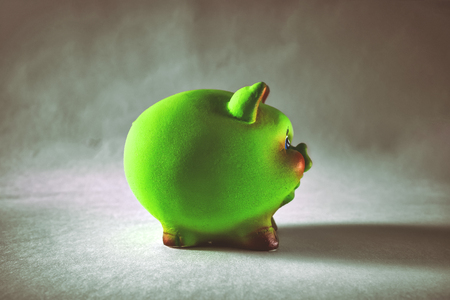 Green ceramic piggy Bank on white backgroundの写真素材