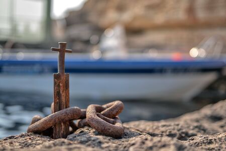 old rusty chains and bitts on the background of the sea, natural light
