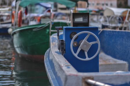 Dashboard and steering wheel of an old motor boat. Natural lightの写真素材