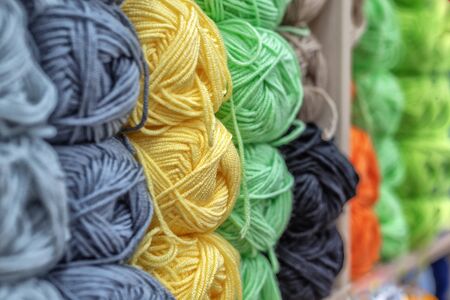 Multicolored wool balls of yarn. Background of colored yarn balls. Embroidery. Knitting. Hobbies and leisure.の写真素材