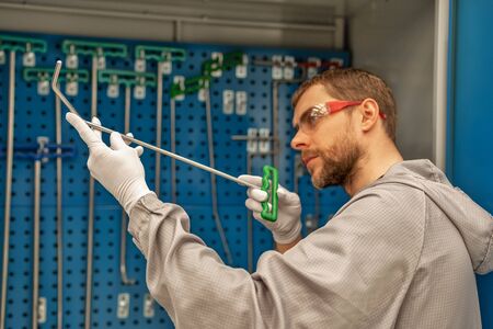 An employee of an automobile plant selects a tool to eliminate metal defects. Straighteningの写真素材