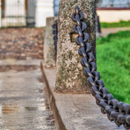 Limiting the passage of decorative chain in the city Park. Selective focus, natural lightの写真素材