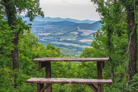 view from the mountain through the forest to the settlements in the valley. Recreation area on...