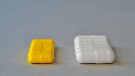 Yellow and white capsules are isolated on a blue background. Top view with space for copying....