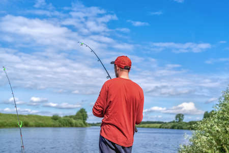 A fisherman catches fish on the river. Natural light. Amateur fishing