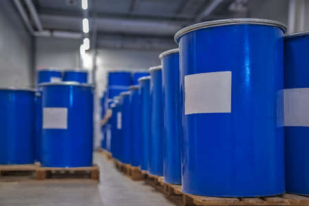 Blue metal barrels. Chemical industry. Metal barrels for chemicals. Storage racks. Barrels are...