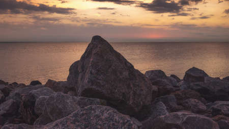 Rocky beach with sunset background. Beautiful landscape, natural lightの写真素材