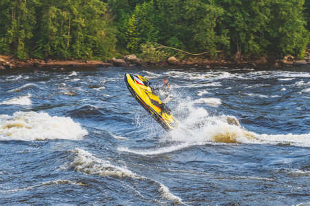 Stunt ride on a jet ski on a rough river. Natural light
