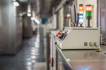 remote control of the conveyor at the automobile plant. Selective focus. Industrial interior.