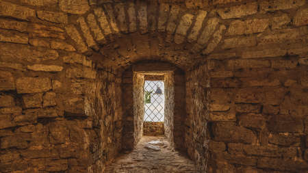 Interior of the old fortress tower. The window embrasures, thick walls.の写真素材