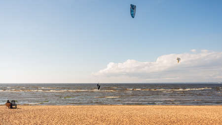The kitesurfer is riding on the waves of the Bay. Natural light