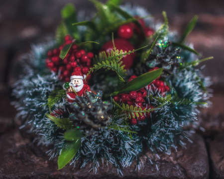 Christmas wreath on a brick wall background. Christmas decorations with Santa Claus figurine. Christmas decor. Close upの写真素材