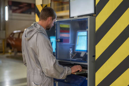 worker of the car factory paint shop at the computer. Industrial interiorの写真素材