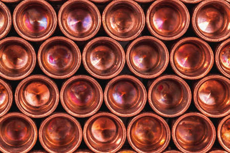 Copper pipes in neat rows close-up. Selective focus. Background.