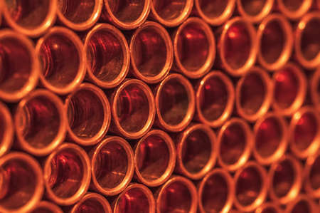 Copper pipes in neat rows close-up. Selective focus. Background.の写真素材