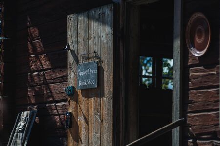 An old shop in a wooden house with an open door