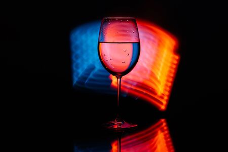 Glass for wine against the backdrop of bright color solutions . Glass table.の写真素材