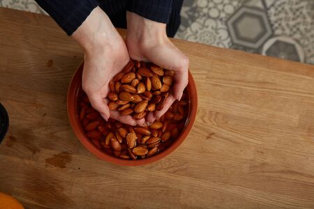 Girl cooks almonds and make almond milkの写真素材