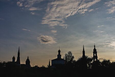 Silhouettes of a classic view of Russia with churches at sunset.の写真素材